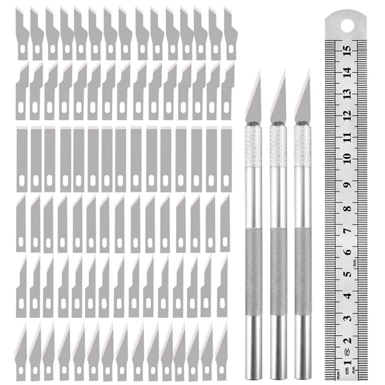 Craft knives, blades, and a ruler arranged on a white background